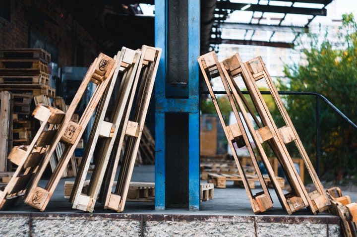Staged pallets obstructing a marked egress route on the plant floor